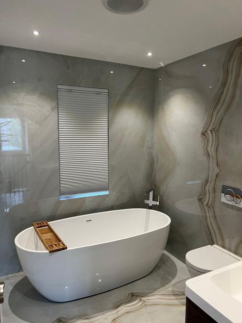 Primary bath — freestanding tub & porcelain-slab walls